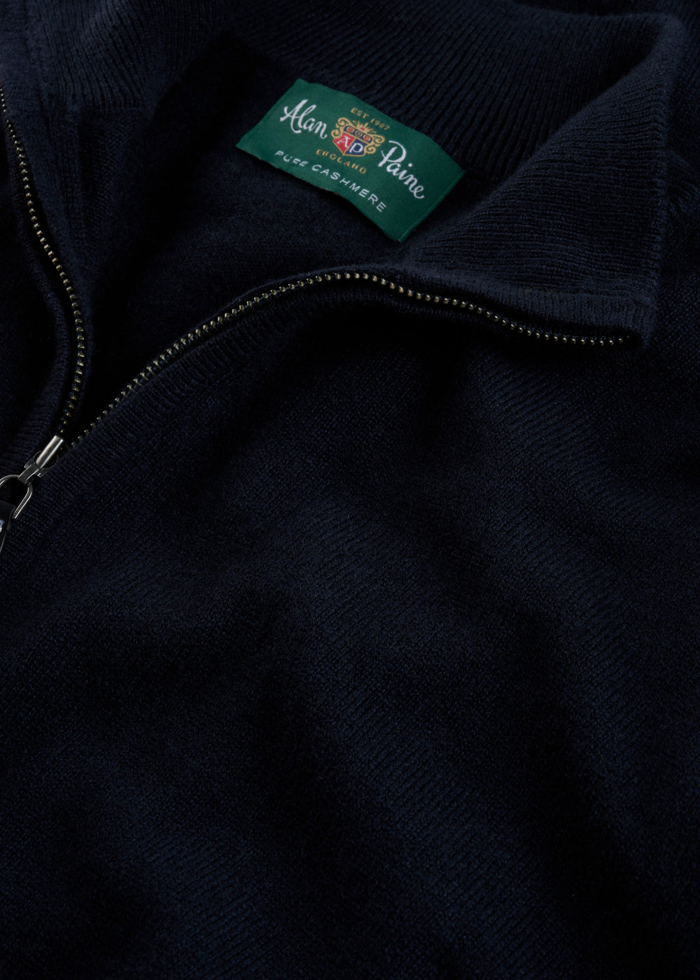 Close-up of a Hanbury Pure Cashmere Quarter Zip Jumper in Dark Navy, label visible inside collar.