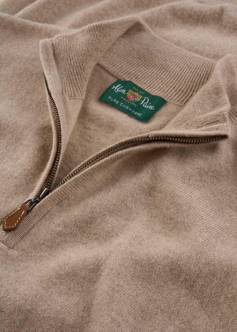 Hanbury Pure Cashmere Quarter Zip Jumper in Linen, regular fit, laid flat with zipper partially open and green label.