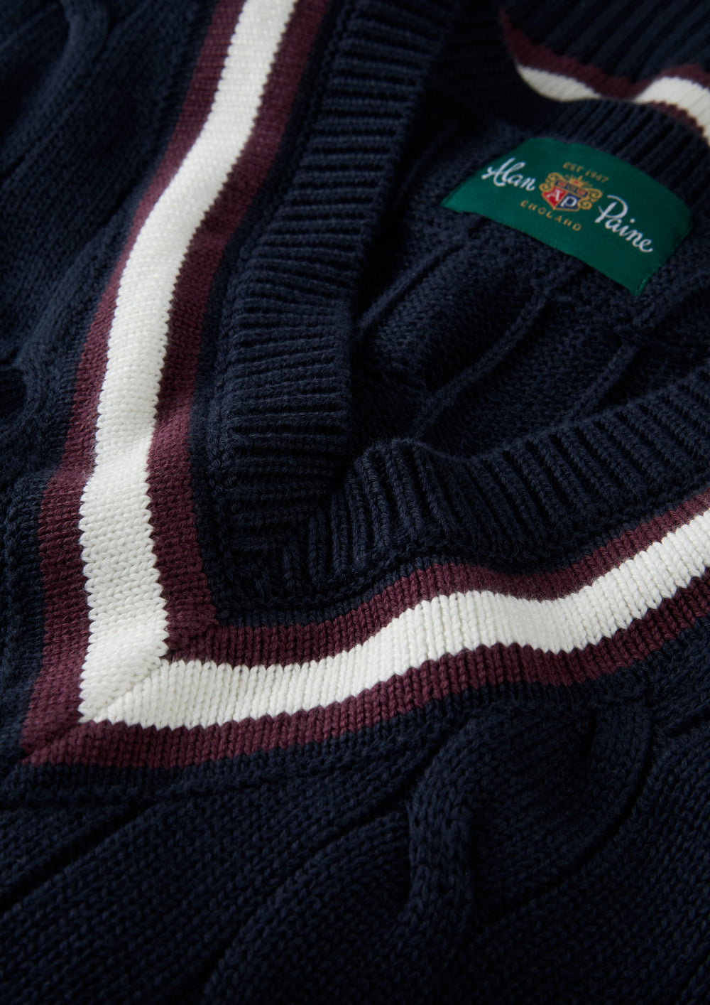 Close-up of Chadbury cotton cable V-neck cricket slipover in dark navy and blackcurrant, regular fit.