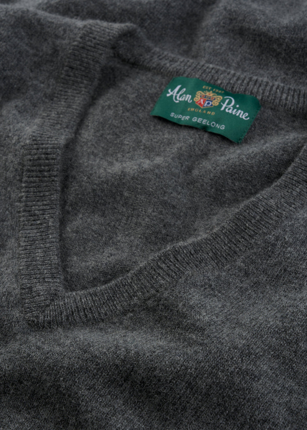 Close-up of gray Albury Geelong Wool V-Neck Jumper in Derby, regular fit, label visible inside neckline.
