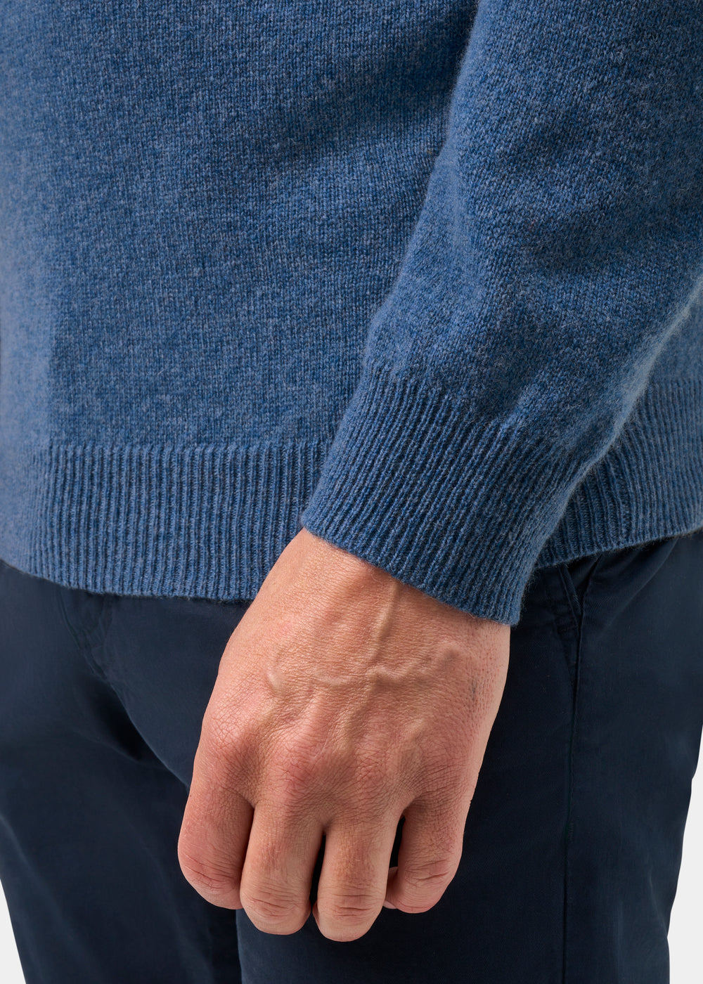 Model wears the Lenzie Lambswool Crew Neck Jumper in Jeans—regular fit—paired with dark pants, hand at their side.
