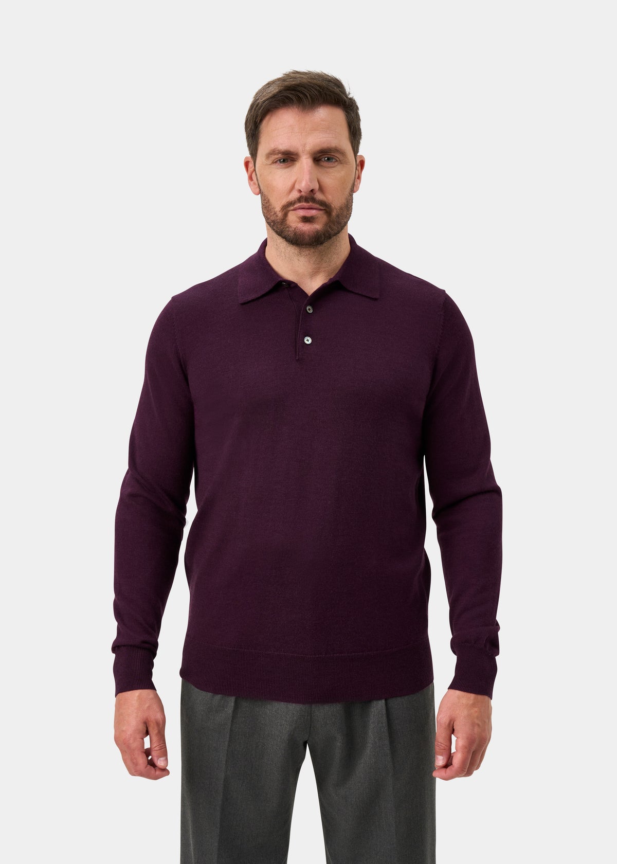 Man wearing Hindhead Men’s Merino Wool Polo Shirt in Black Grape, standing against a plain light background.