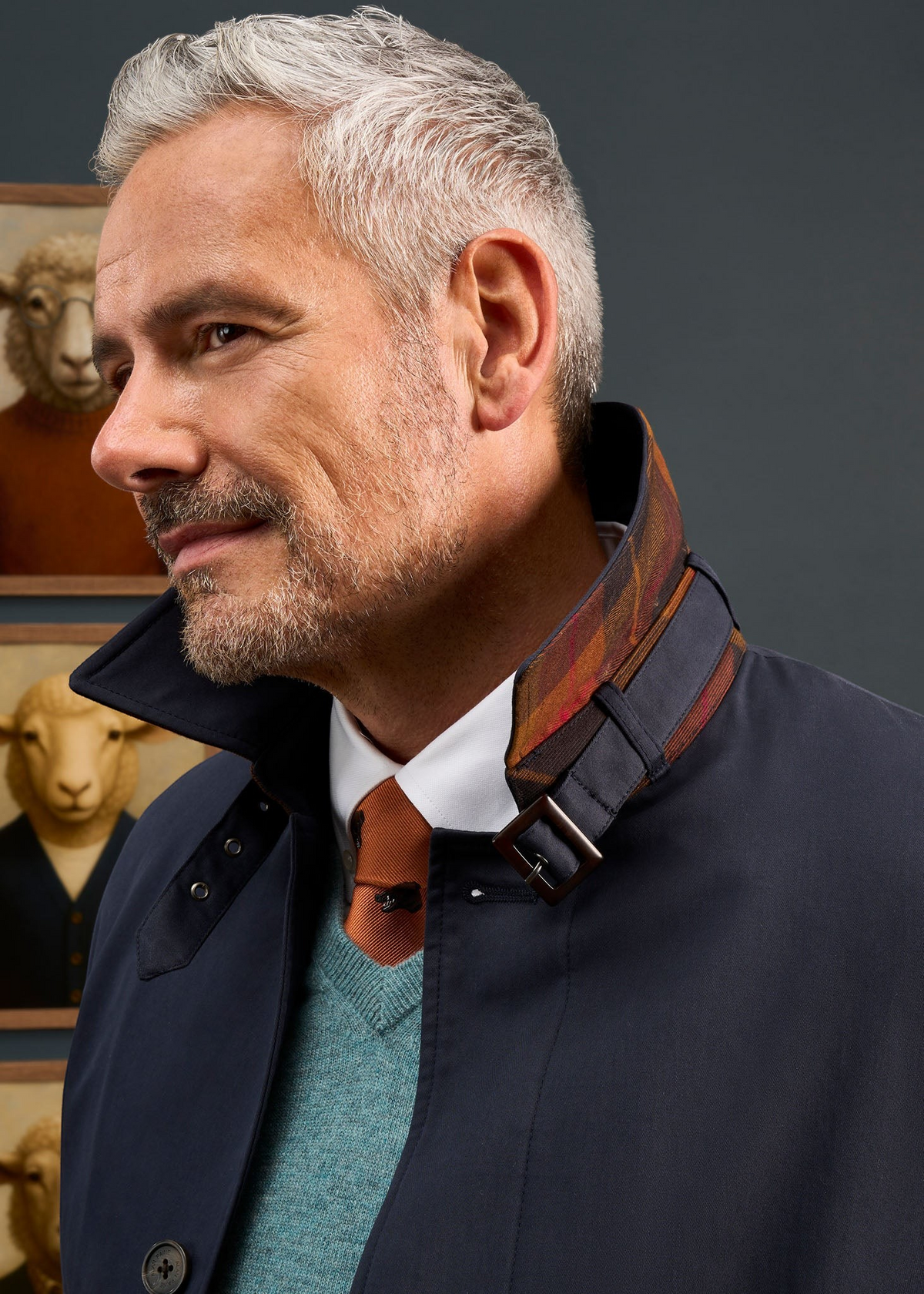 Alan Paine Mistfield navy raincoat with collar stand buckle detail and check lining worn by a man
