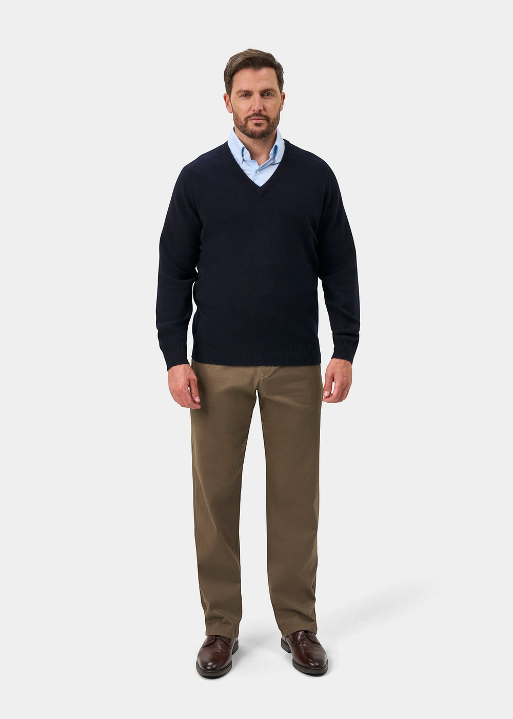 Alan Paine navy V-neck lambswool jumper worn by a man with a light blue shirt and brown trousers