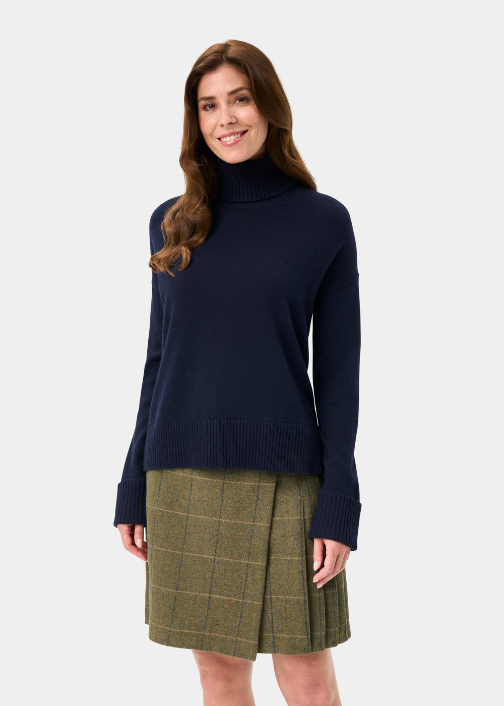 Woman in the Alexa Wool & Cashmere Roll Neck Jumper in Dark Navy, smiling against a plain background.