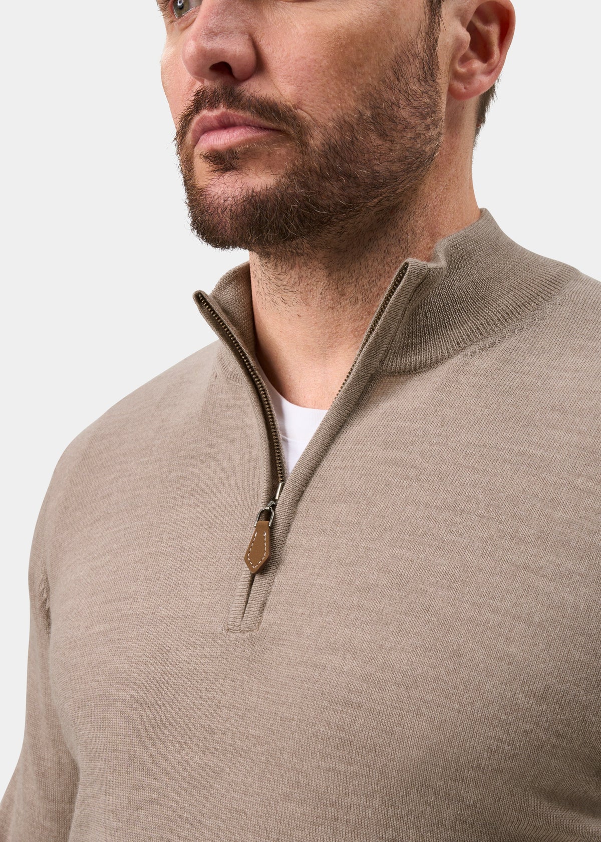 Man in Barton Merino Wool Quarter Zip Jumper in Cobble, regular fit, over white shirt, plain background.