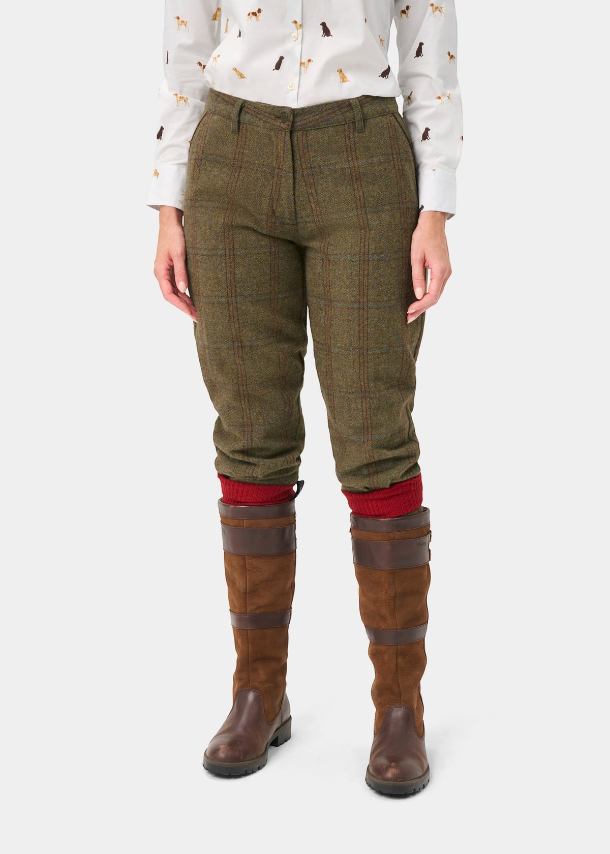 Combrook Ladies Tweed Shooting Breeks in Laurel, brown boots, red socks, and a dog-print white shirt complete this look.
