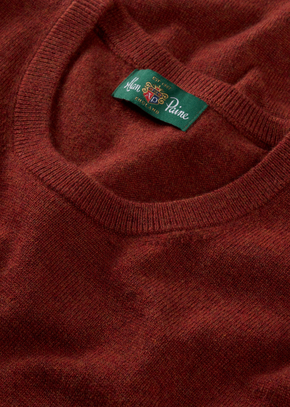 Close-up of the Ivy Wool & Cashmere Crew Neck Jumper in Autumn, a perfect ladies’ knit with a green neckline label.