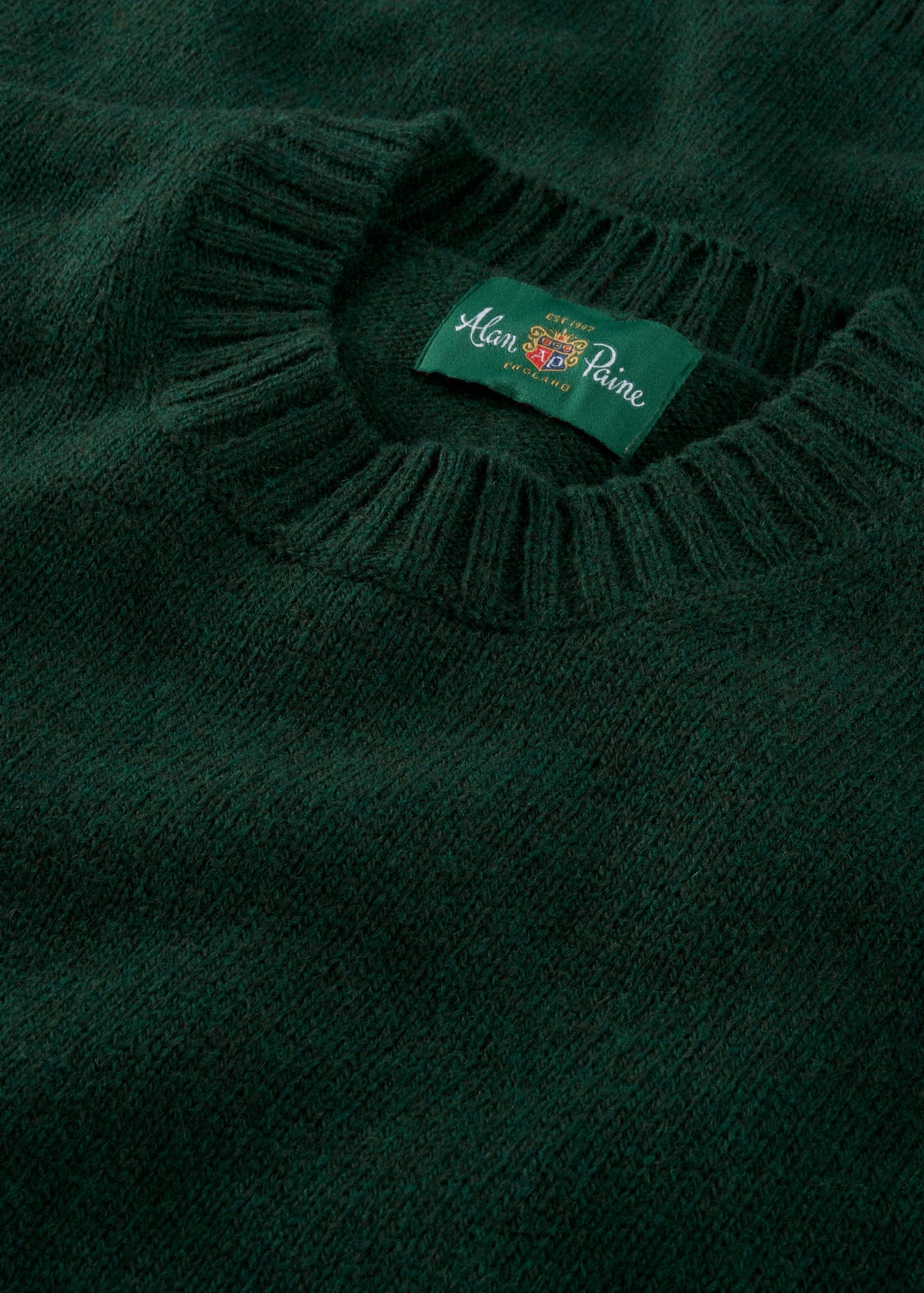 Close-up of the Kinnadie Supersoft Shetland Wool Crew Neck Jumper in Cossack, regular fit, with Alan Paine label.