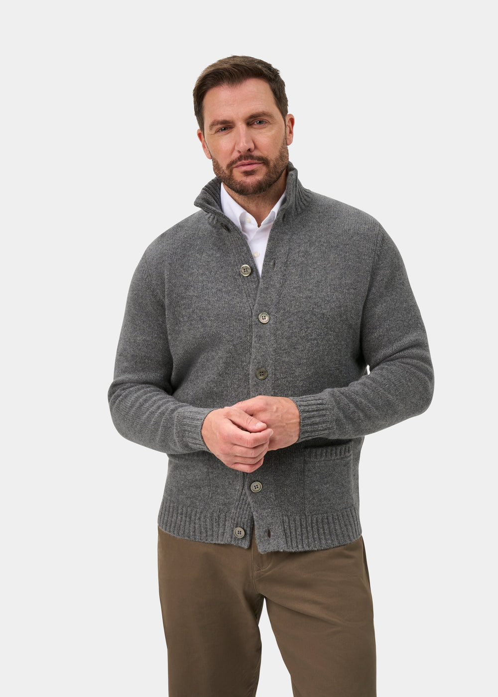 Man in Landford Lambswool Mock Neck Jumper (Grey Mix), white shirt, brown pants, on plain white background.