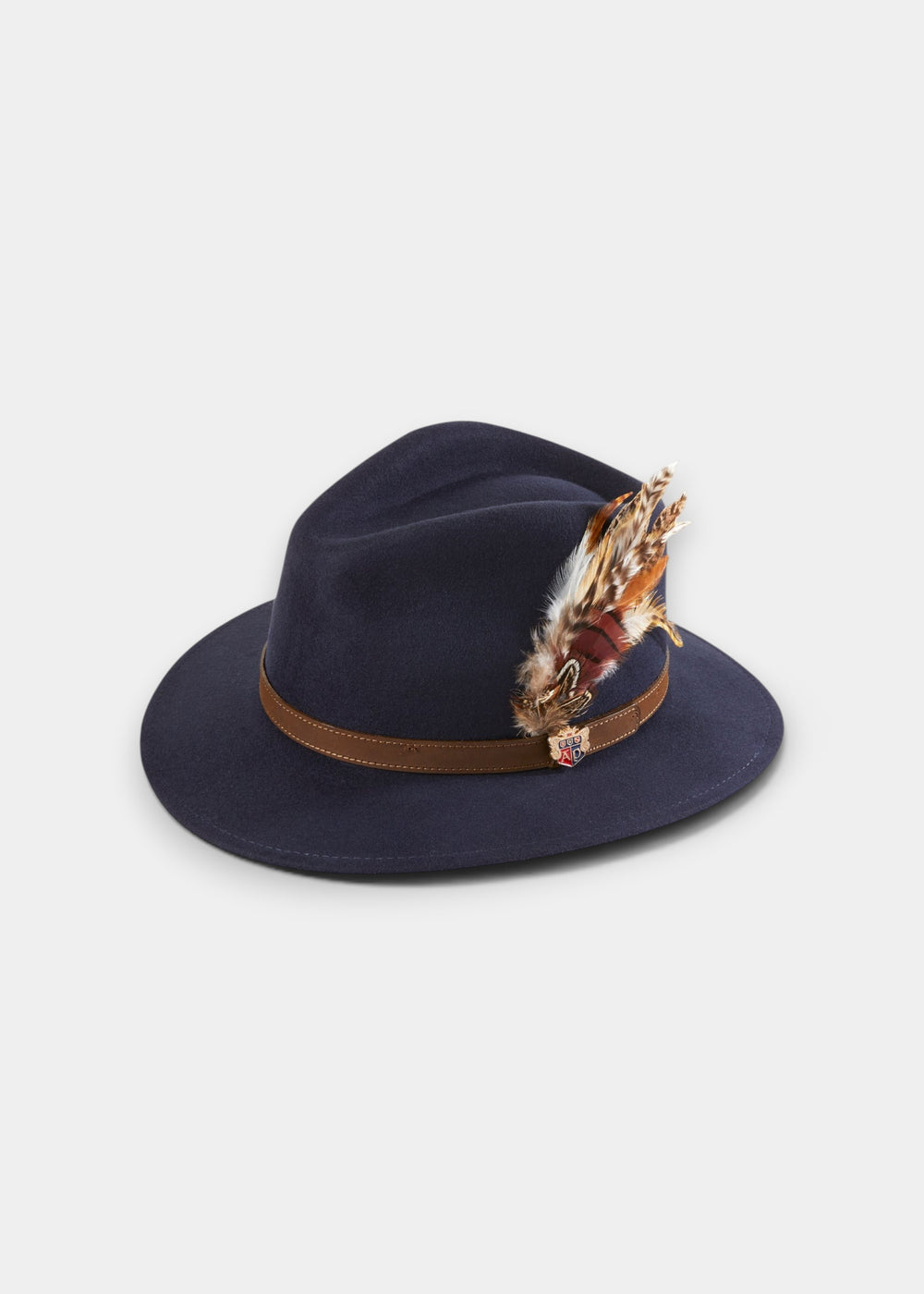 Richmond Unisex Felt Hat With Feather In Navy: a wool felt fedora with a brown band, feather, and small metal emblem.