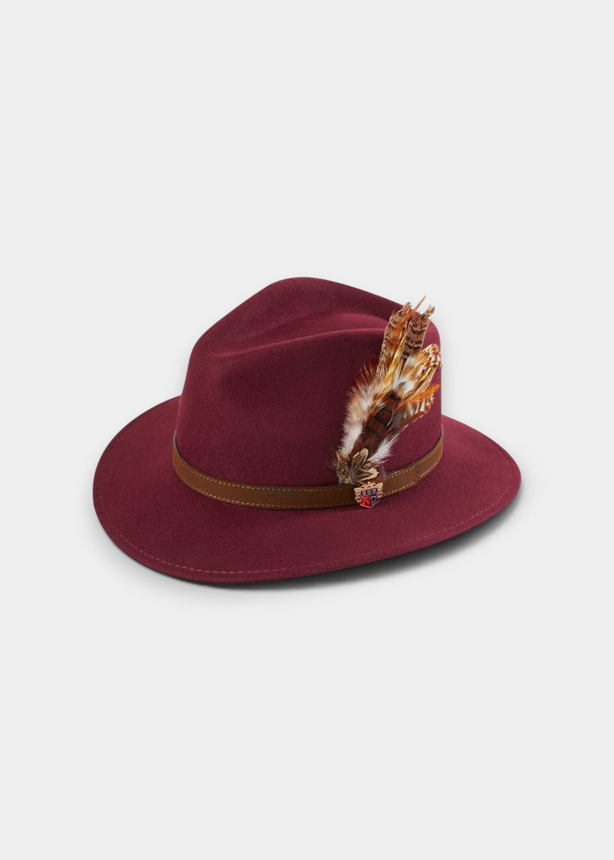Richmond Unisex Felt Hat With Feather In Wine, a wine-colored wool fedora with a brown leather band and decorative feather.